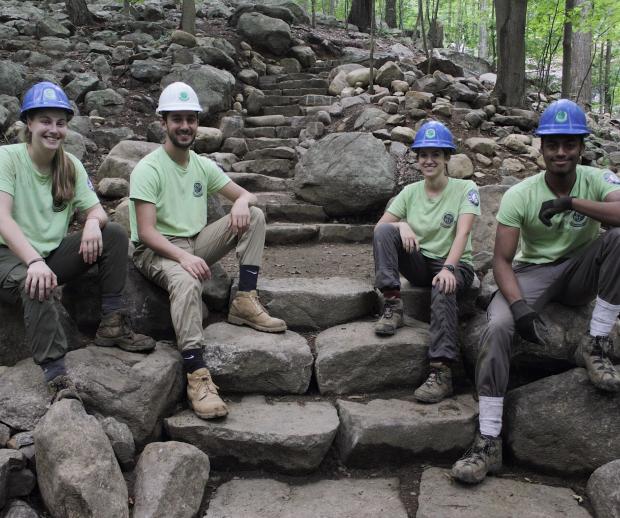 Sweet Water Trail Crew proudly sitting on their stone steps built on the Ramapo Valley County Reservation Vista Loop. Photo by Brayden Donnelly.