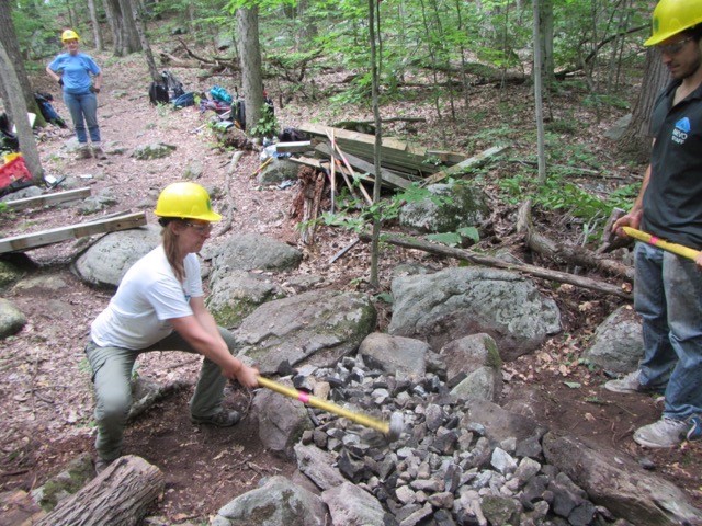 Crushing stone to build a causeway.